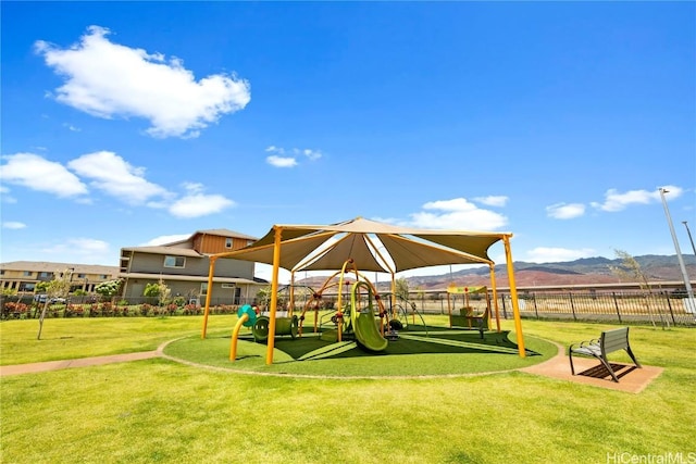 view of play area with a mountain view and a lawn