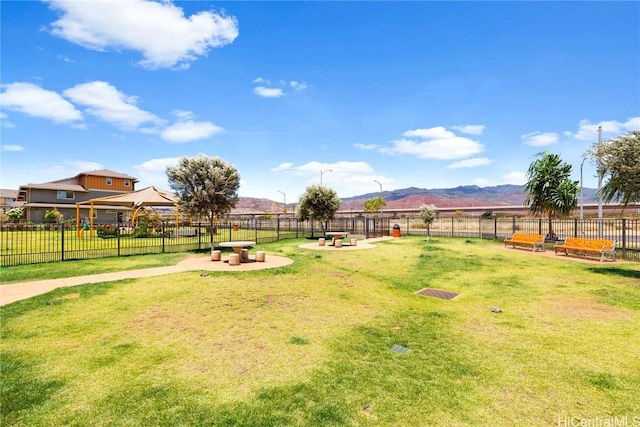 view of yard with a rural view and a mountain view