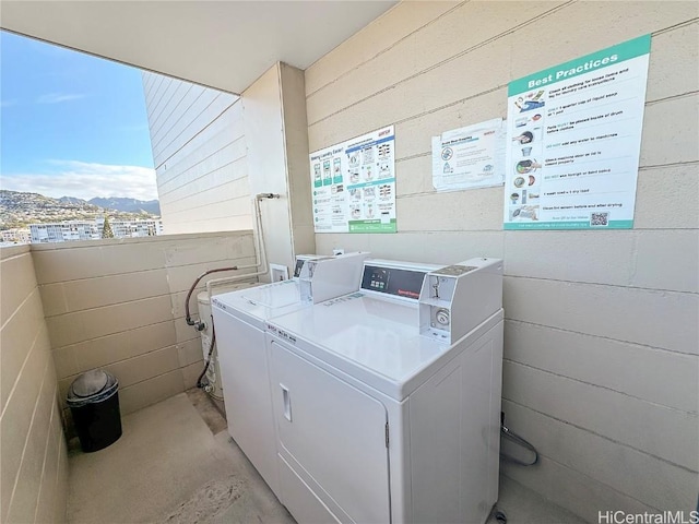 laundry room featuring separate washer and dryer and a mountain view