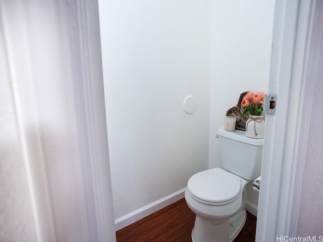 bathroom with toilet and hardwood / wood-style flooring