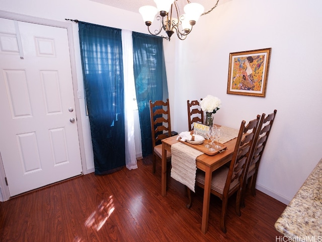 dining space with an inviting chandelier and dark hardwood / wood-style floors