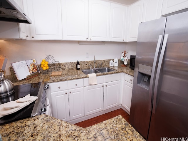 kitchen featuring extractor fan, stainless steel appliances, stone countertops, white cabinets, and sink