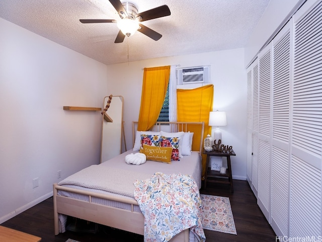 bedroom featuring a textured ceiling, ceiling fan, a closet, and dark hardwood / wood-style floors