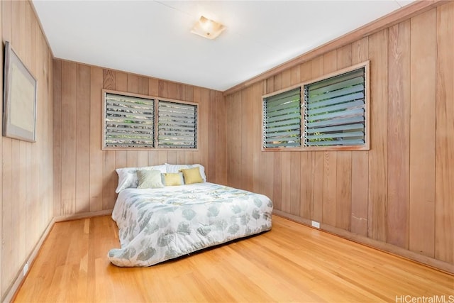 bedroom featuring hardwood / wood-style floors and wooden walls