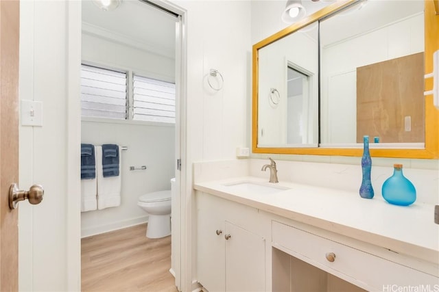 bathroom with vanity, hardwood / wood-style floors, and toilet