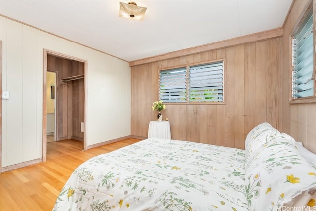 bedroom with hardwood / wood-style flooring and wooden walls