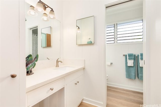 bathroom with vanity, hardwood / wood-style floors, and toilet