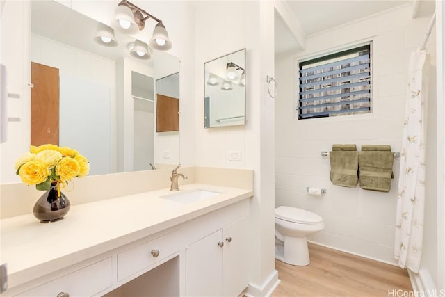 bathroom featuring vanity, hardwood / wood-style floors, and toilet