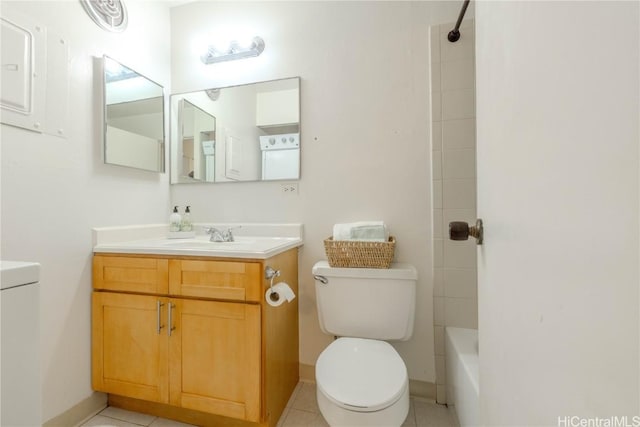 full bathroom with tiled shower / bath, tile patterned flooring, vanity, and toilet