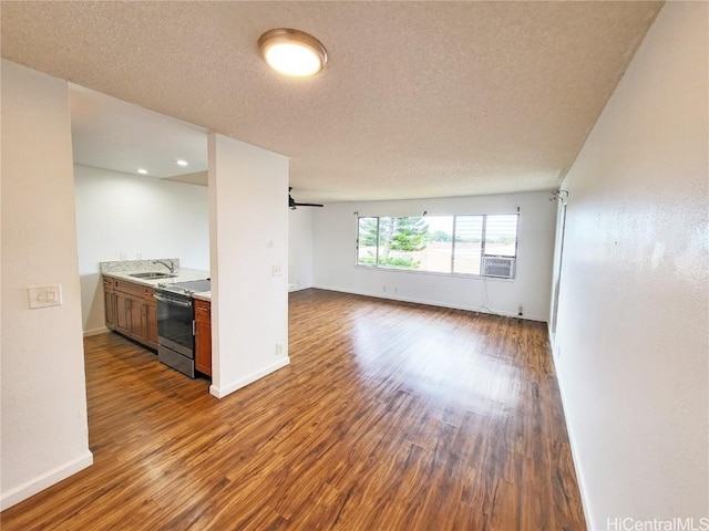 interior space with sink, cooling unit, a textured ceiling, and dark hardwood / wood-style floors