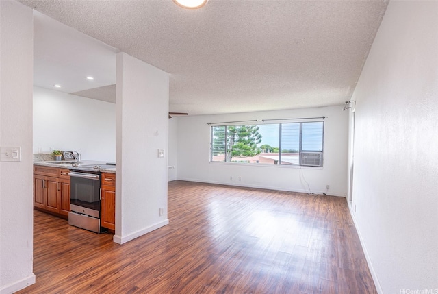 46-263 Kahuhipa St Unit B312, Kaneohe, HI 96744 - unfurnished living room with a sink, dark wood-style floors, baseboards, and a textured ceiling