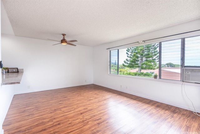 46-263 Kahuhipa St Unit B312, Kaneohe, HI 96744 - spare room featuring wood finished floors, a ceiling fan, a textured ceiling, baseboards, and cooling unit