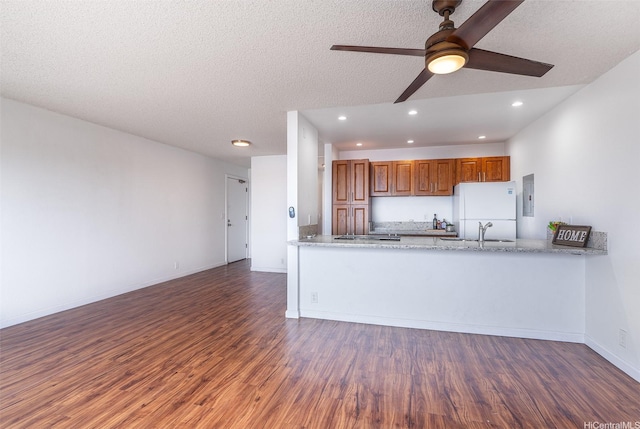 46-263 Kahuhipa St Unit B312, Kaneohe, HI 96744 - kitchen featuring freestanding refrigerator, a sink, brown cabinets, wood finished floors, and a ceiling fan