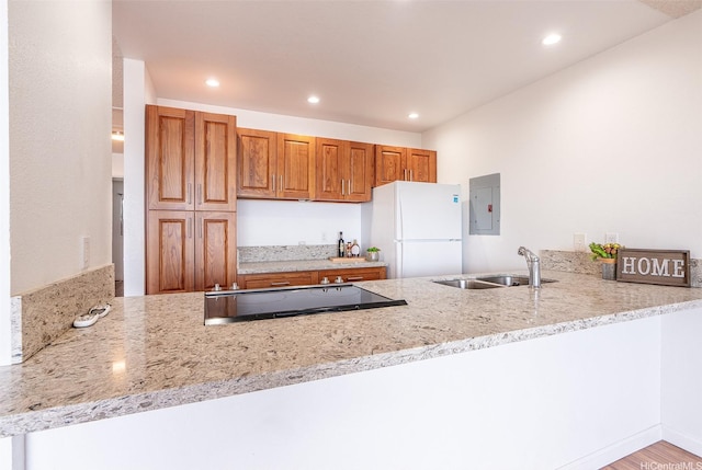 46-263 Kahuhipa St Unit B312, Kaneohe, HI 96744 - kitchen with freestanding refrigerator, a peninsula, a sink, electric panel, and recessed lighting
