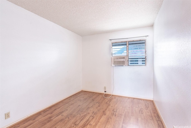 46-263 Kahuhipa St Unit B312, Kaneohe, HI 96744 - unfurnished room with light wood-type flooring, a textured ceiling, and baseboards