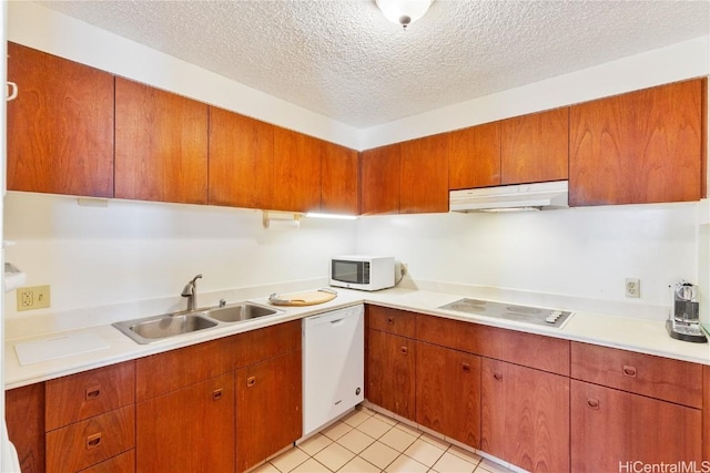 kitchen featuring sink, white appliances, a textured ceiling, and light tile patterned flooring