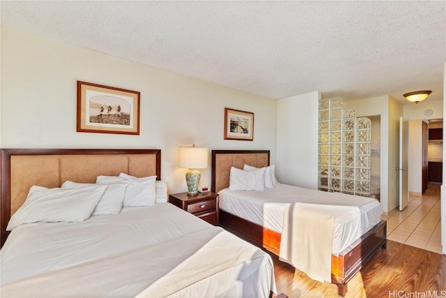 bedroom featuring a textured ceiling and hardwood / wood-style floors