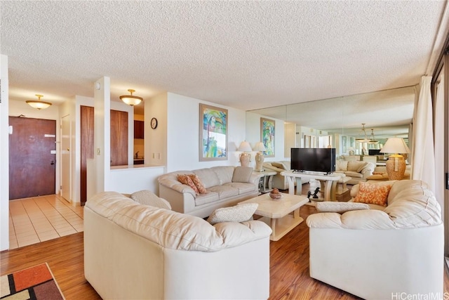 living room with a textured ceiling and hardwood / wood-style floors