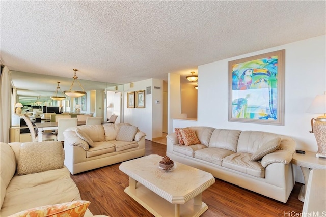 living room with dark wood-type flooring and a textured ceiling