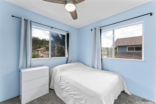 bedroom featuring ceiling fan and dark colored carpet