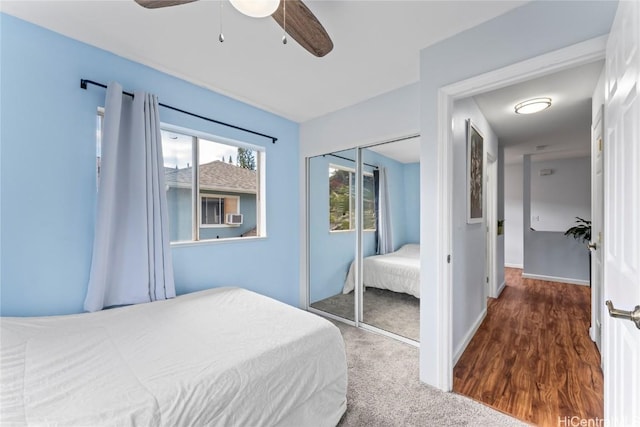 bedroom with hardwood / wood-style flooring, ceiling fan, and a closet