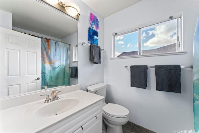 bathroom with toilet and vanity