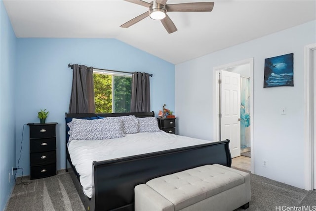 carpeted bedroom featuring lofted ceiling, connected bathroom, and ceiling fan