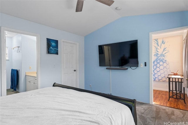 bedroom with ceiling fan, vaulted ceiling, carpet flooring, and connected bathroom