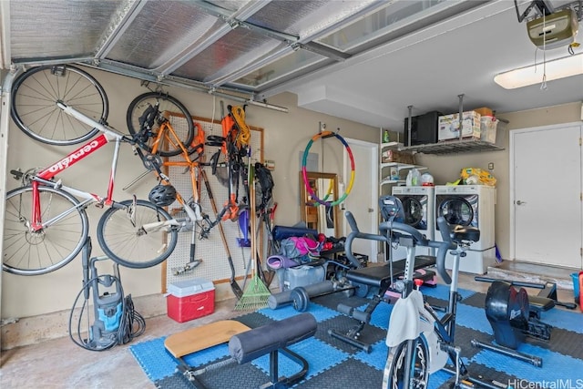 garage with a garage door opener and washing machine and clothes dryer