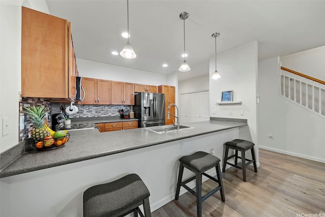 478 Kunehi St Unit 105, Kapolei, HI 96707 - kitchen with stainless steel appliances, a sink, a peninsula, decorative backsplash, and recessed lighting