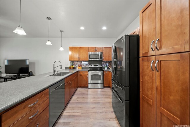 478 Kunehi St Unit 105, Kapolei, HI 96707 - kitchen with stainless steel appliances, a sink, light wood finished floors, brown cabinetry, and decorative light fixtures
