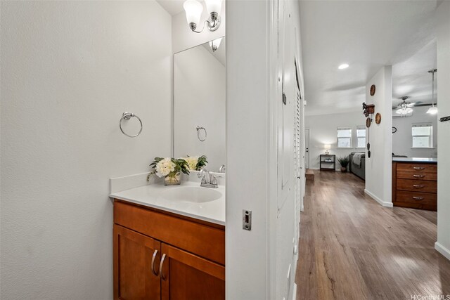 478 Kunehi St Unit 105, Kapolei, HI 96707 - ensuite bathroom featuring wood finished floors, vanity, a ceiling fan, baseboards, and recessed lighting