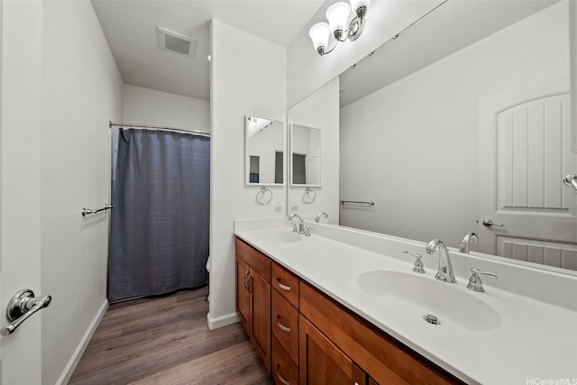 478 Kunehi St Unit 105, Kapolei, HI 96707 - full bathroom featuring wood finished floors, double vanity, and baseboards