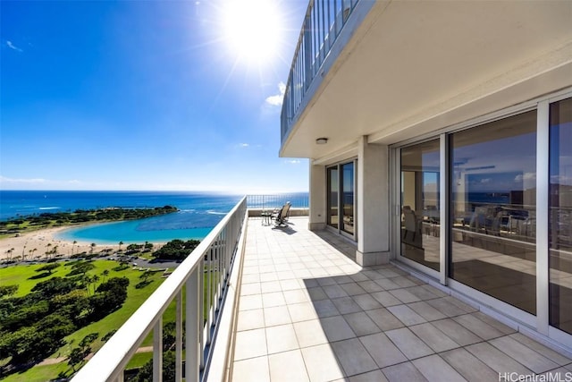 balcony featuring a water view and a beach view