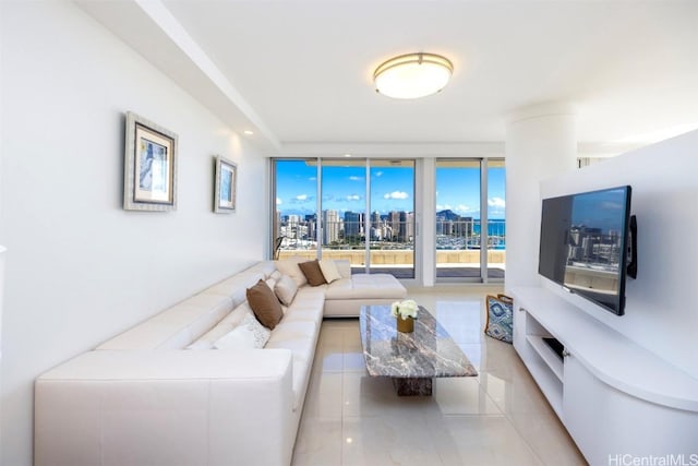 living room featuring light tile patterned flooring and floor to ceiling windows