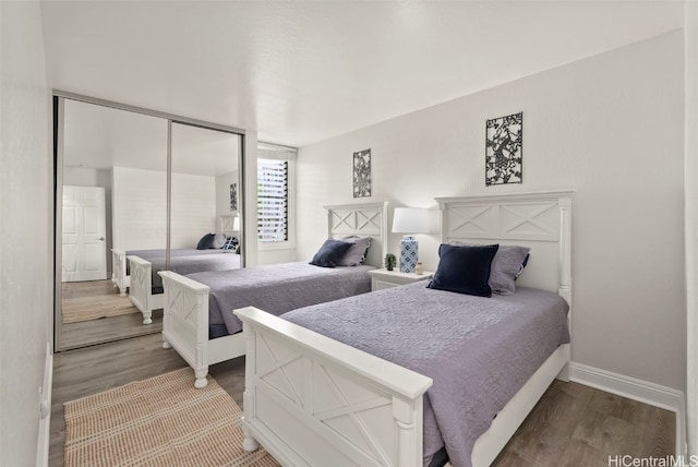 bedroom featuring wood-type flooring and a closet