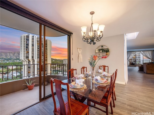 dining area with a notable chandelier and hardwood / wood-style floors