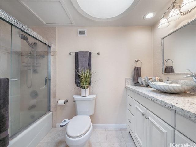 full bathroom featuring toilet, combined bath / shower with glass door, tile patterned floors, and vanity