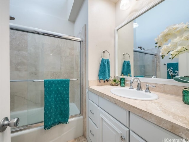 bathroom with vanity and combined bath / shower with glass door