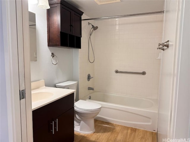 full bathroom featuring toilet, vanity, hardwood / wood-style flooring, and shower / bath combination