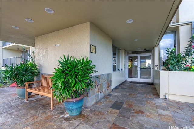 entrance to property featuring french doors and a patio area