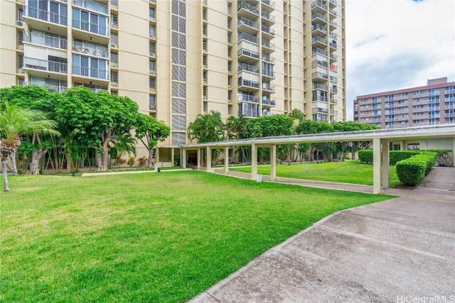 view of property's community with a lawn