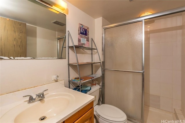 bathroom featuring toilet, an enclosed shower, and vanity