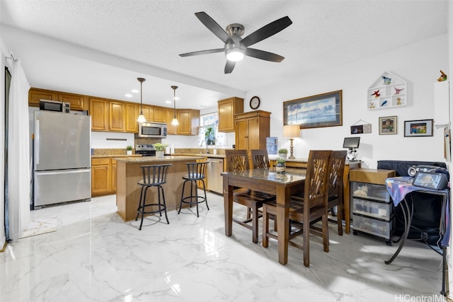 dining area with sink, a textured ceiling, and ceiling fan