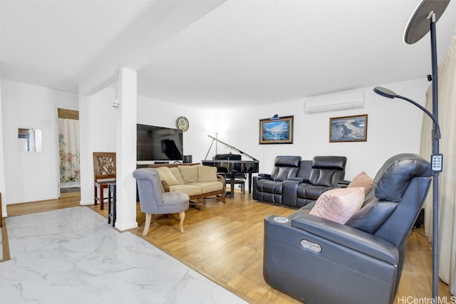 living room with a textured ceiling, hardwood / wood-style floors, and a wall unit AC