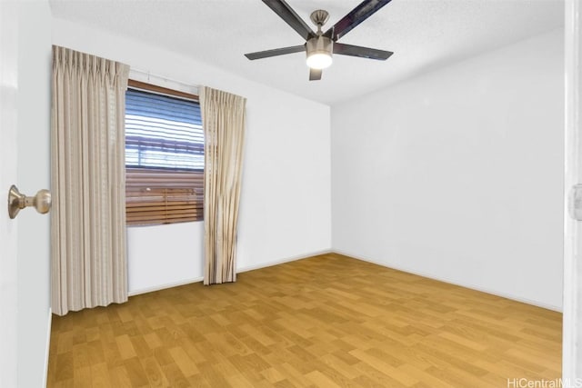 spare room featuring a textured ceiling, ceiling fan, and light hardwood / wood-style flooring