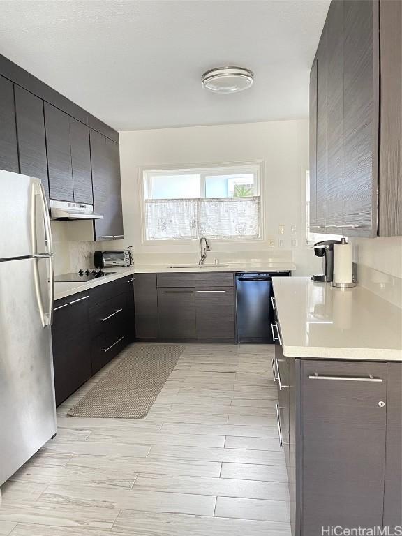 kitchen with sink, light wood-type flooring, and black appliances