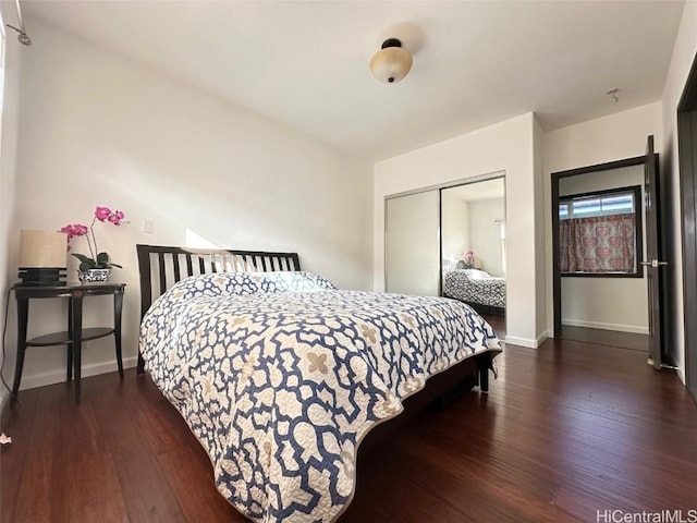 bedroom featuring dark hardwood / wood-style flooring and a closet