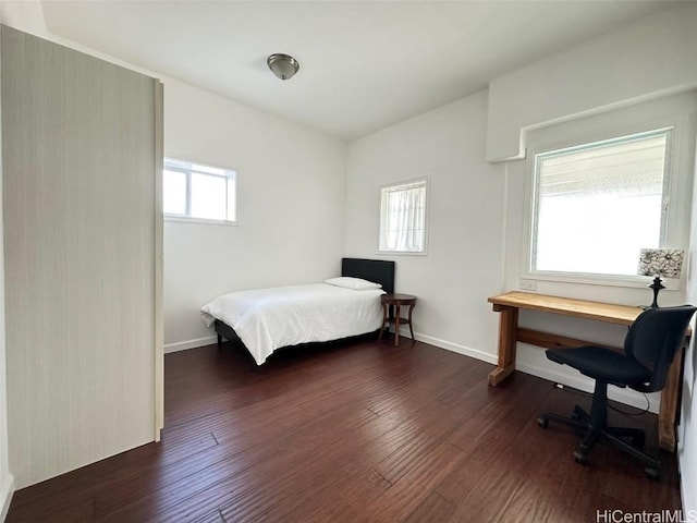 bedroom with dark wood-type flooring