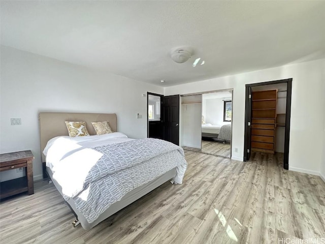 bedroom featuring light hardwood / wood-style flooring and a closet